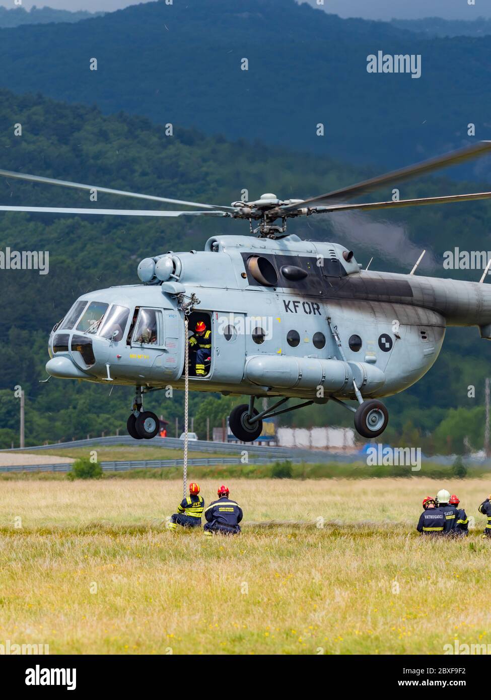Mi-8 MTV1 helicopter of Croatia Air Force HRZ in Grobnik Croatia airport during training exercise flights in behalf interest of firemen holding rope Stock Photo