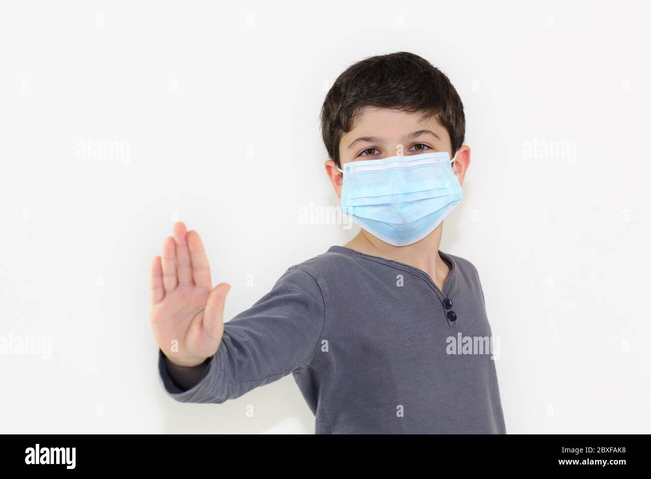 child with a surgical mask on the face - Covid-19 coronavirus barrier gesture well-protected and child who is not afraid to face the epidemic Stock Photo