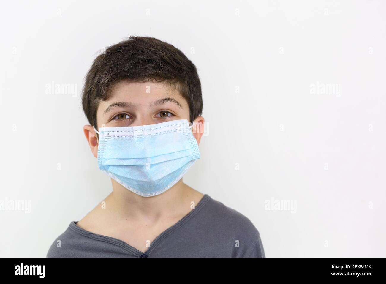 child with a surgical mask on the face - Covid-19 coronavirus barrier gesture well-protected and child who is not afraid to face the epidemic Stock Photo