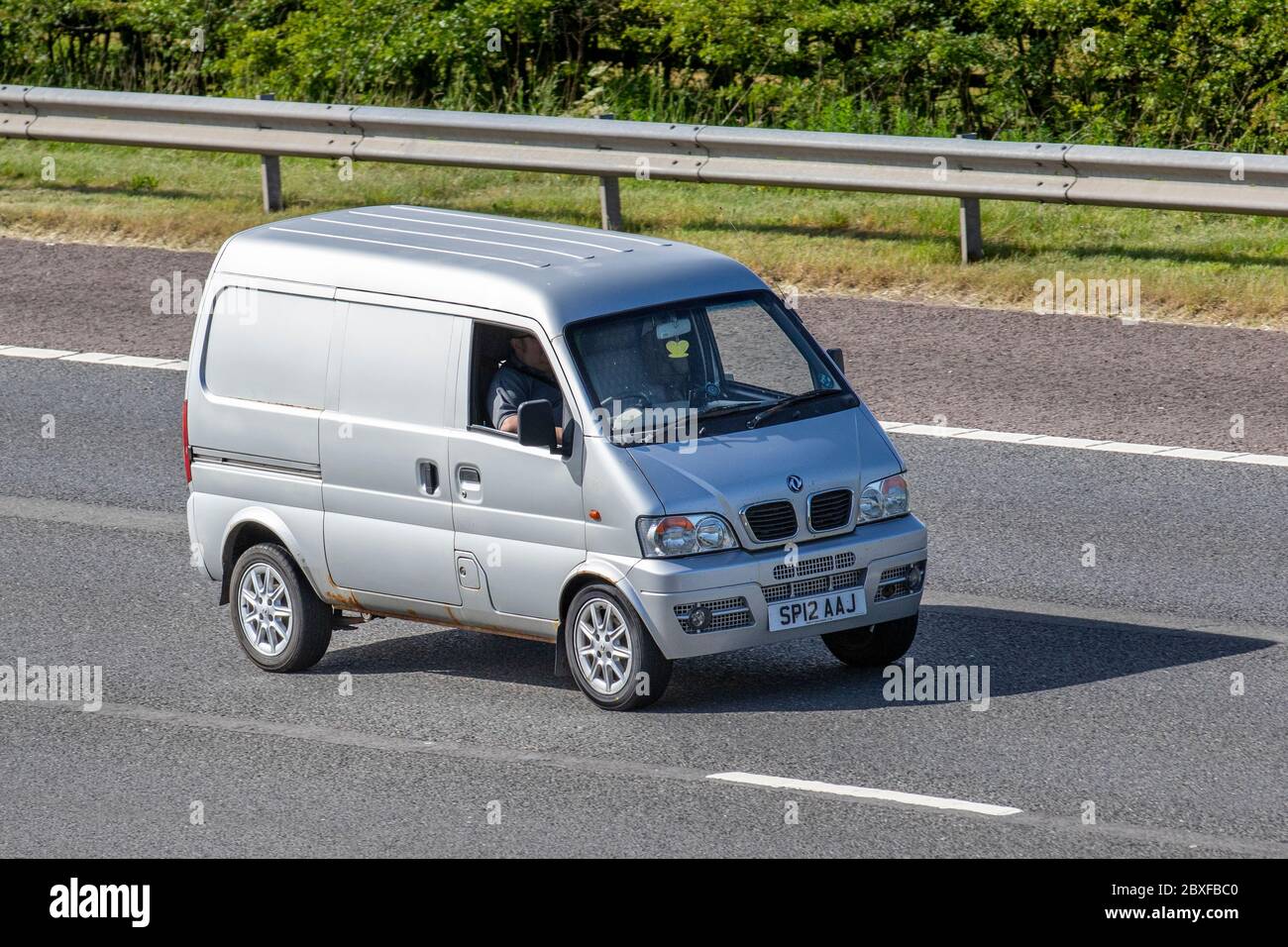 2012 silver Dfsk Loadhopper; Vehicular traffic moving vehicles, cars  driving vehicle on UK roads, motors, motoring on the M6 motorway highway  Stock Photo - Alamy