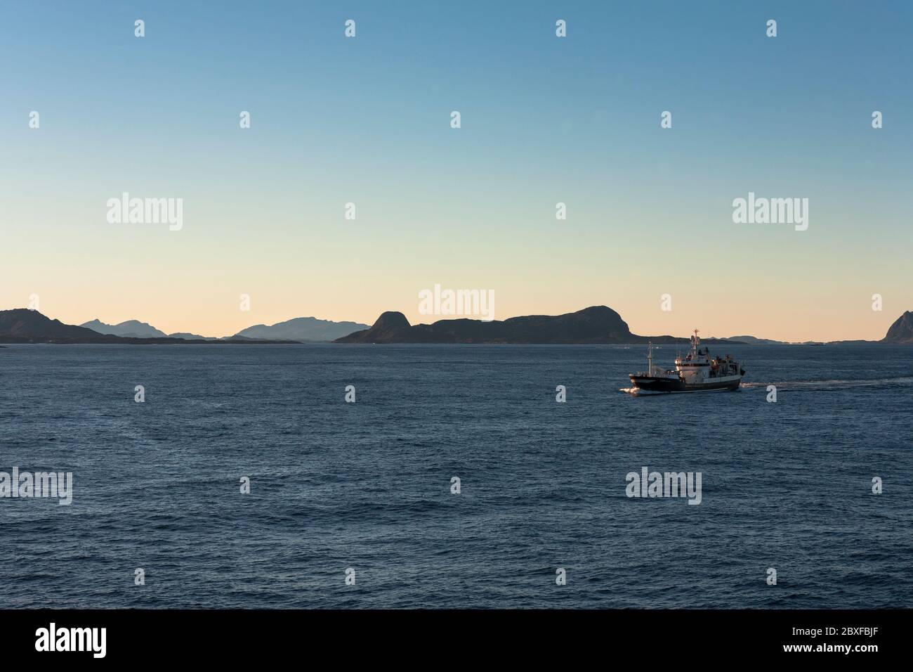 A fishing vessel crosses Smelværosen, Askvoll Municipality, Sogn og Fjordane, Norway Stock Photo