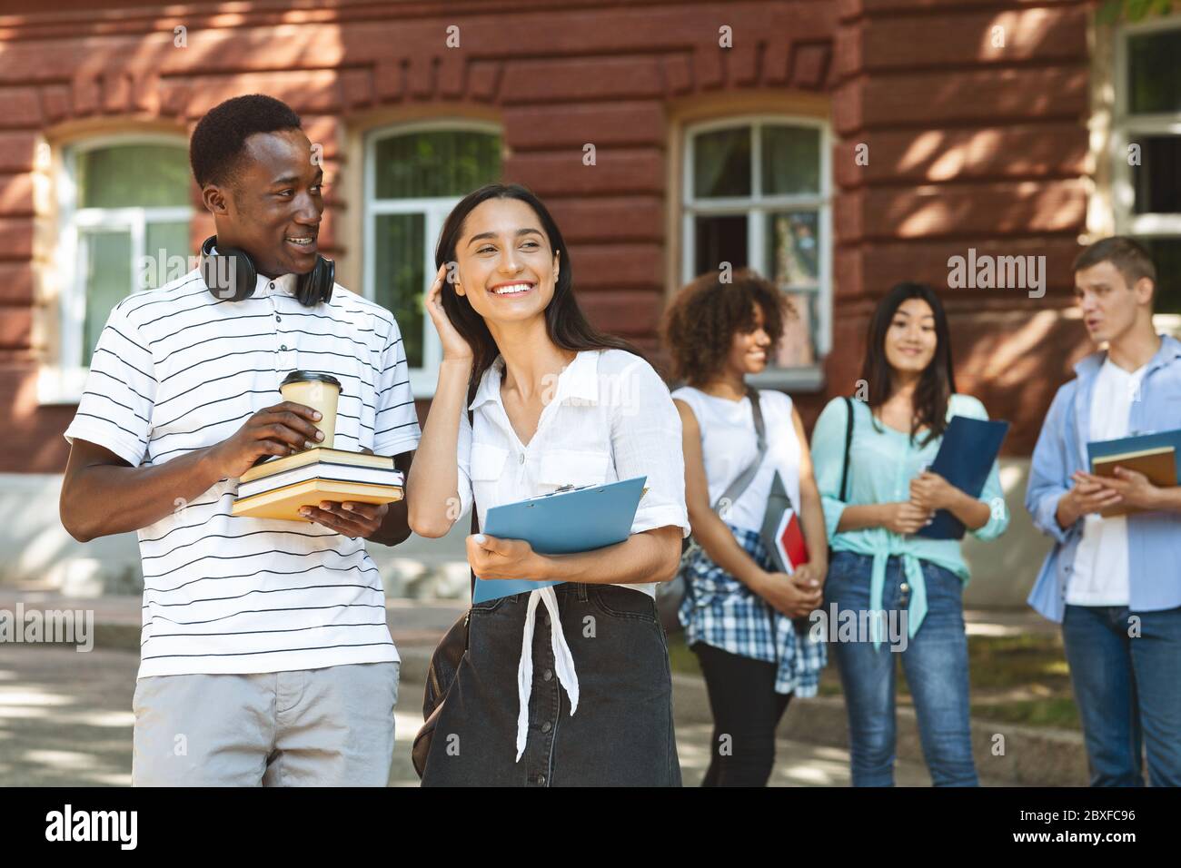 College Time. Happy Students Resting During Break In Campus Stock Photo