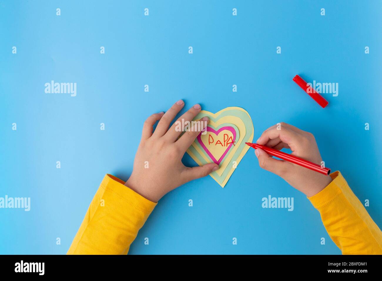 paper craft fathers day card, kids made paper kids hand drowing heart on card Stock Photo
