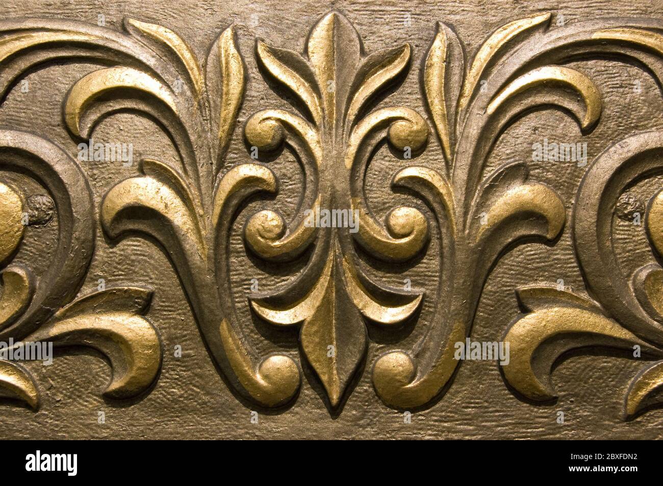 Ornate moulded plaster painted in a golden paint. Outside decoration of a Victorian public House in London. Stock Photo