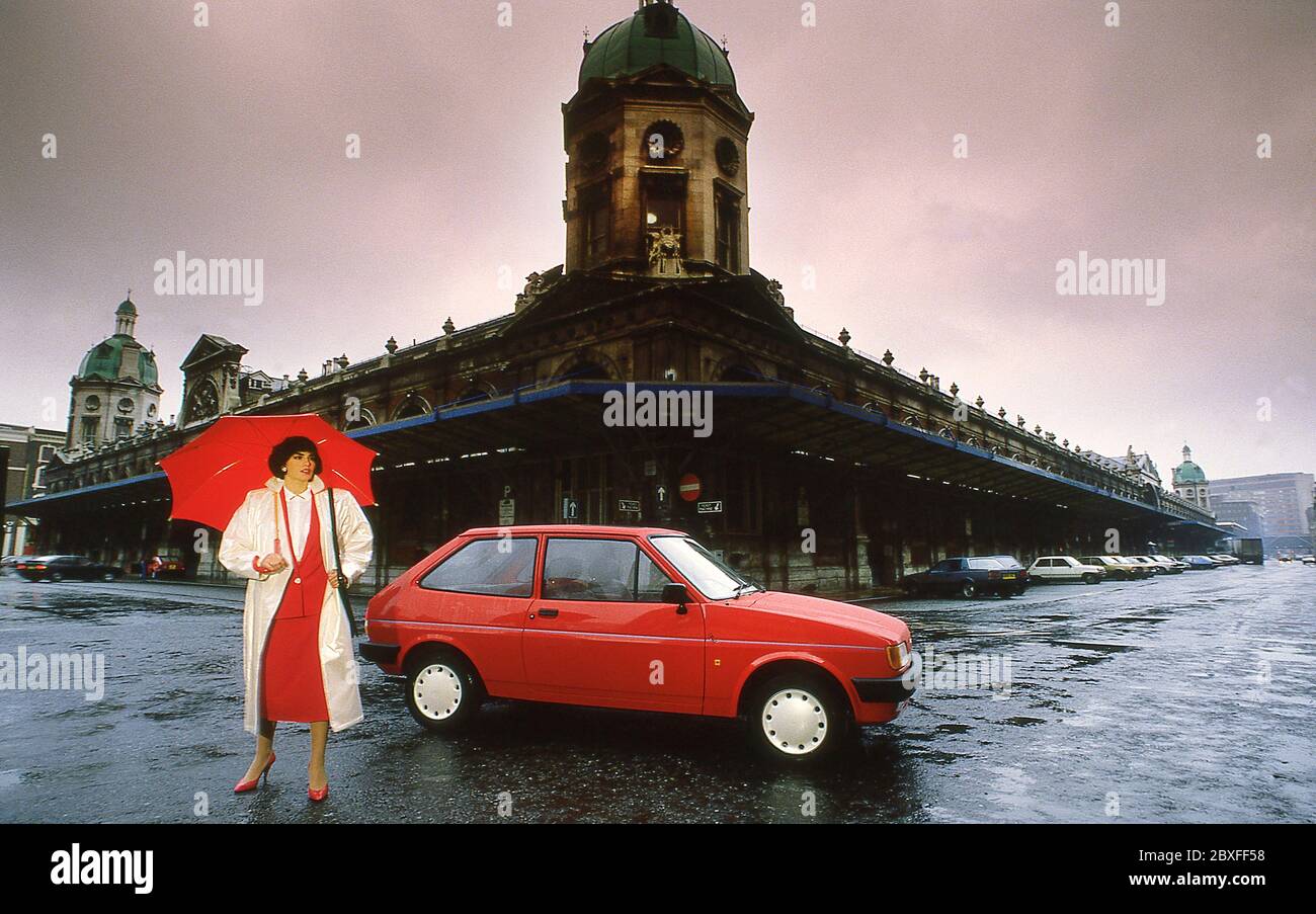 Young Woman with her 1986 Ford Fiesta Finesse in London UK Stock Photo