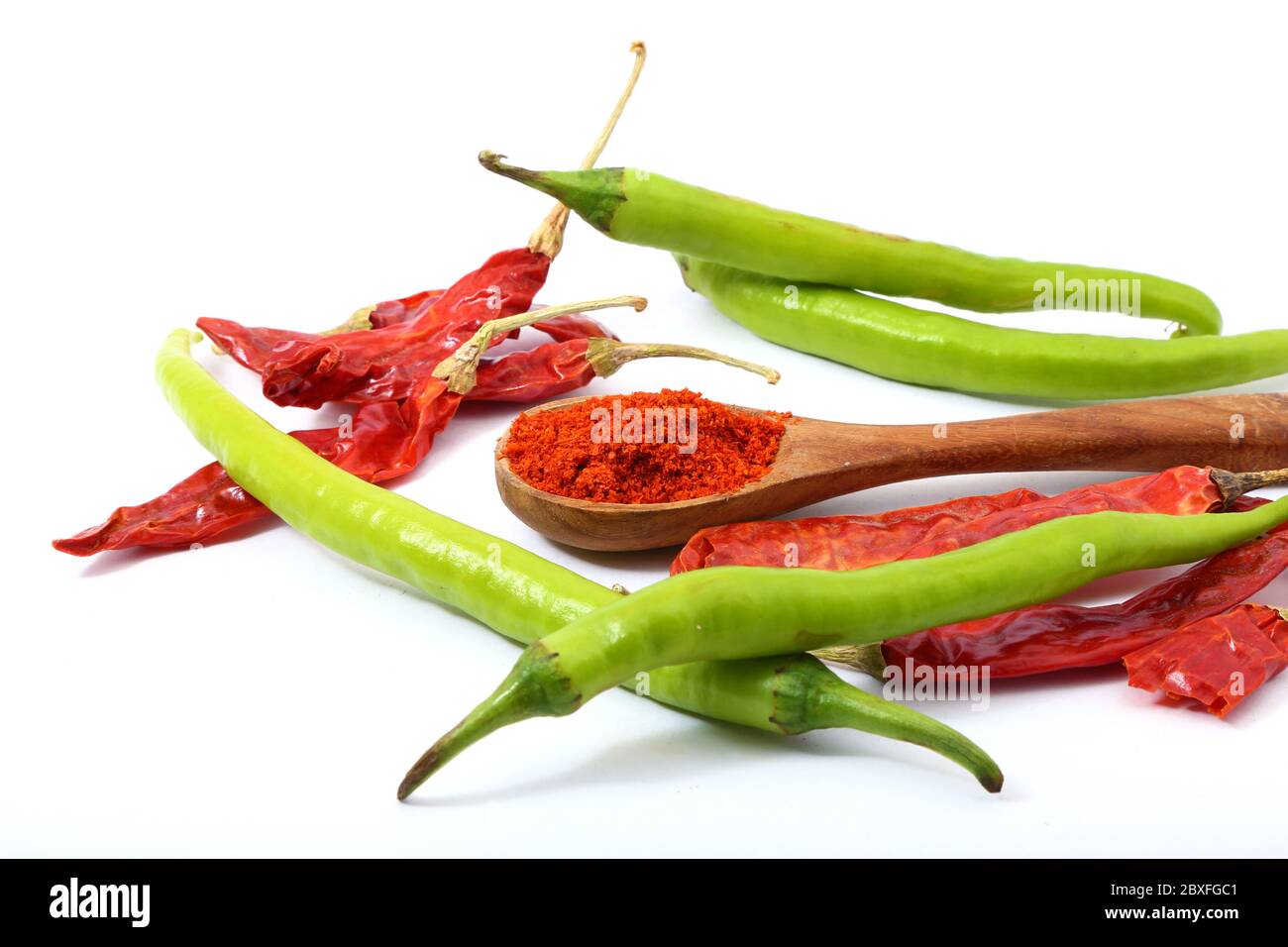 Red chili powder with red green chilies on white background Stock Photo