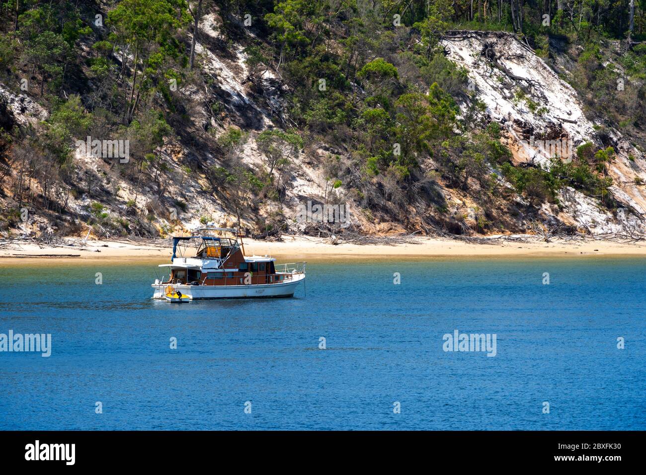 Motor launch anchored of North White Cliffs, Fraser Island, Hervey Bay, Queensland, Australia Stock Photo