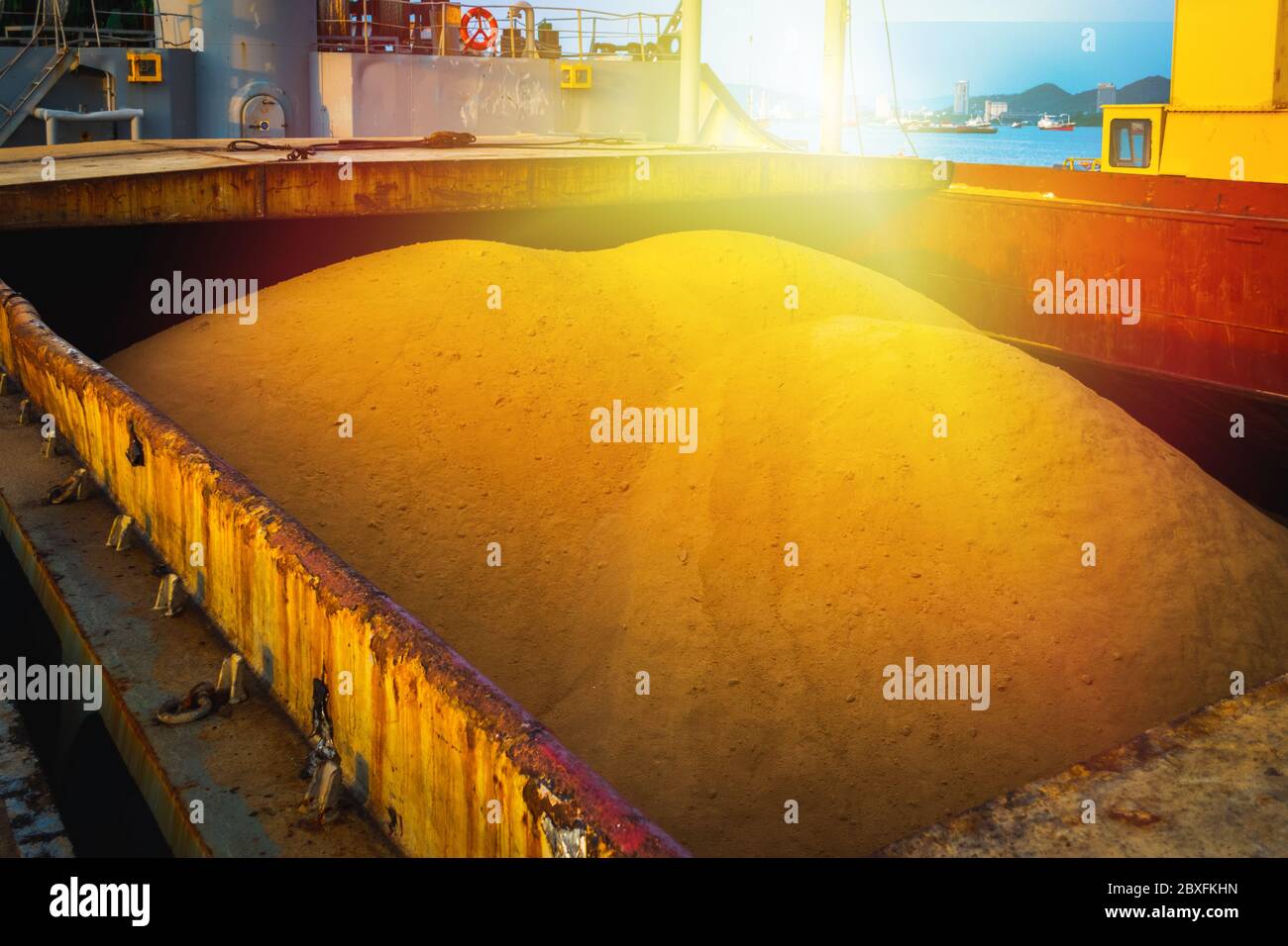 Raw sugar bulk inside large vessel after completed load ready for draft survey. Sugar bulk products transport and handling. Agro-industry concept. Stock Photo