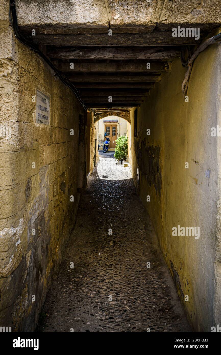 Old covered narrow tunnel street in Medieval Rhodes Town, Rhodes Island, Greece Stock Photo