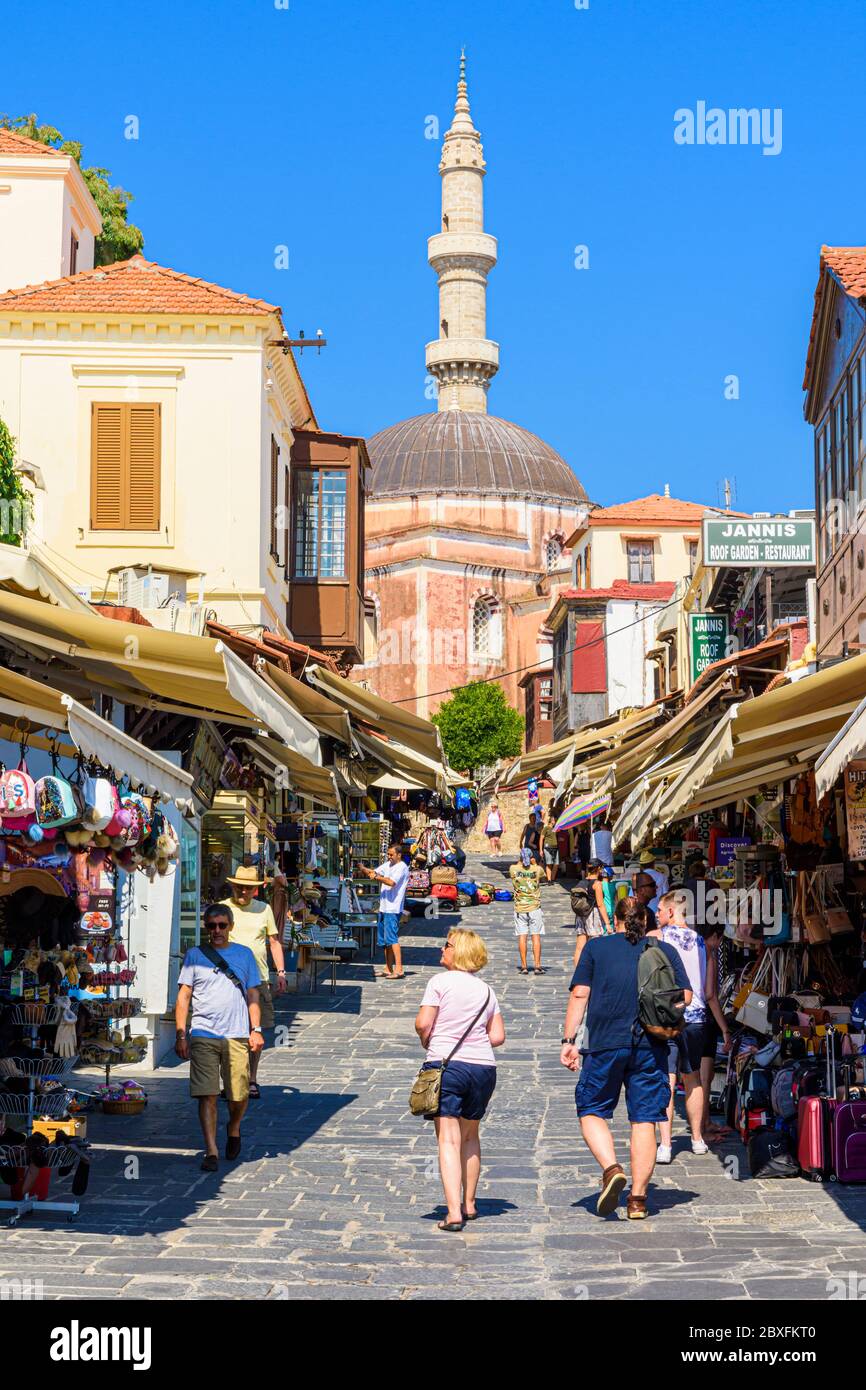 The tourist souvenir shopping street of Socratous St. overlooked by the Mosque of Suleiman, in Rhodes Town, Greece Stock Photo