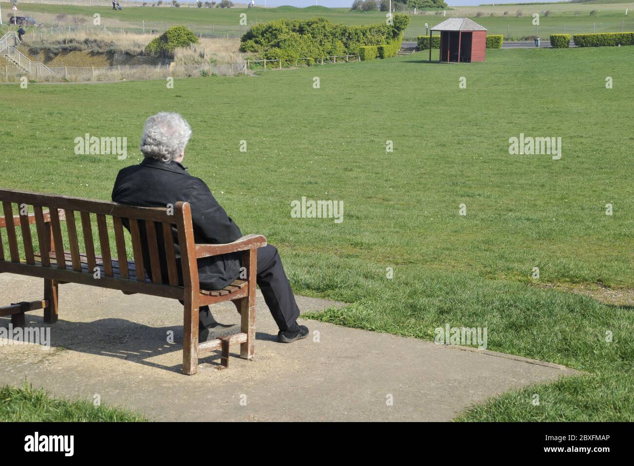 Lonely old man on bench Stock Photo