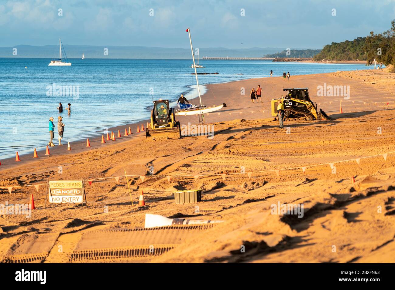 Machinery undertaking beach restoration and erosion control. Scarness Beach Hervey Bay Stock Photo