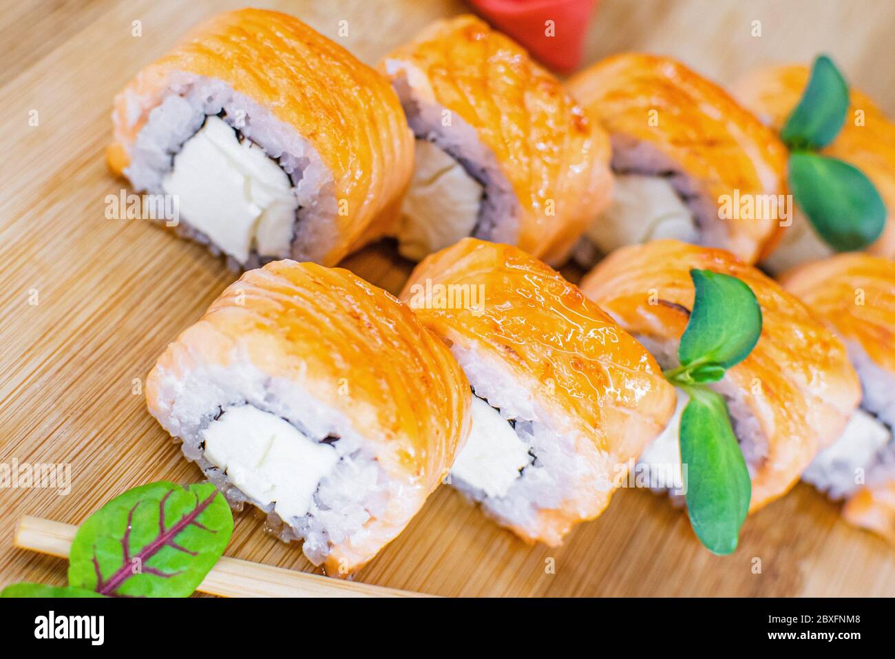 roll with baked salmon and greens, Japanese cuisine Stock Photo