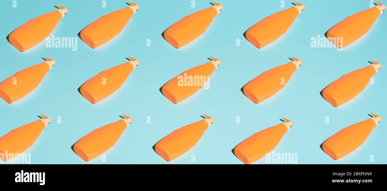 Several orange containers for cosmetics without label on blue background Stock Photo