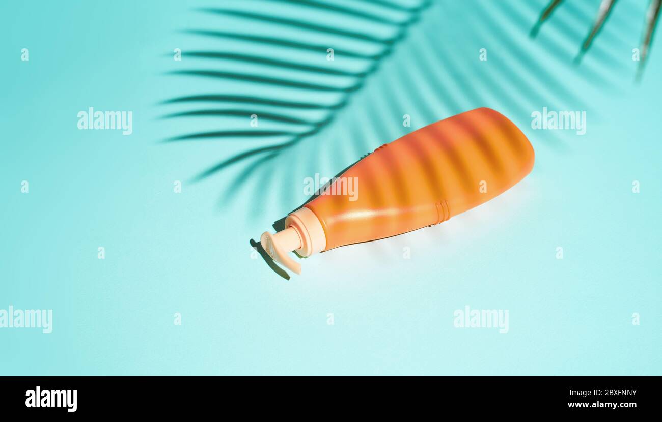 Orange container for cosmetics without label lies on turquoise background Stock Photo