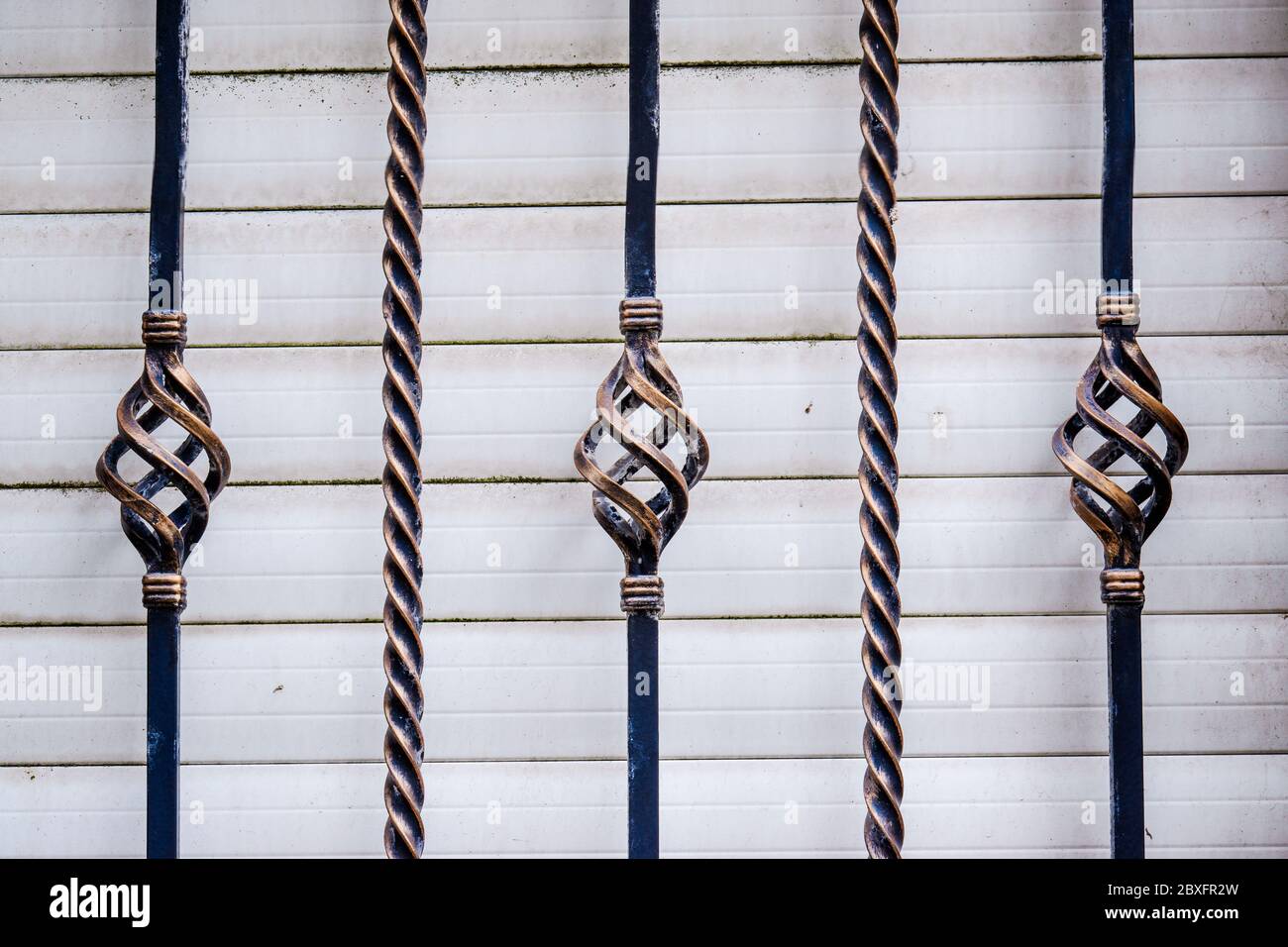 Twisted Bar Railing Twisted iron railing with a white shutter in background UK Stock Photo ...