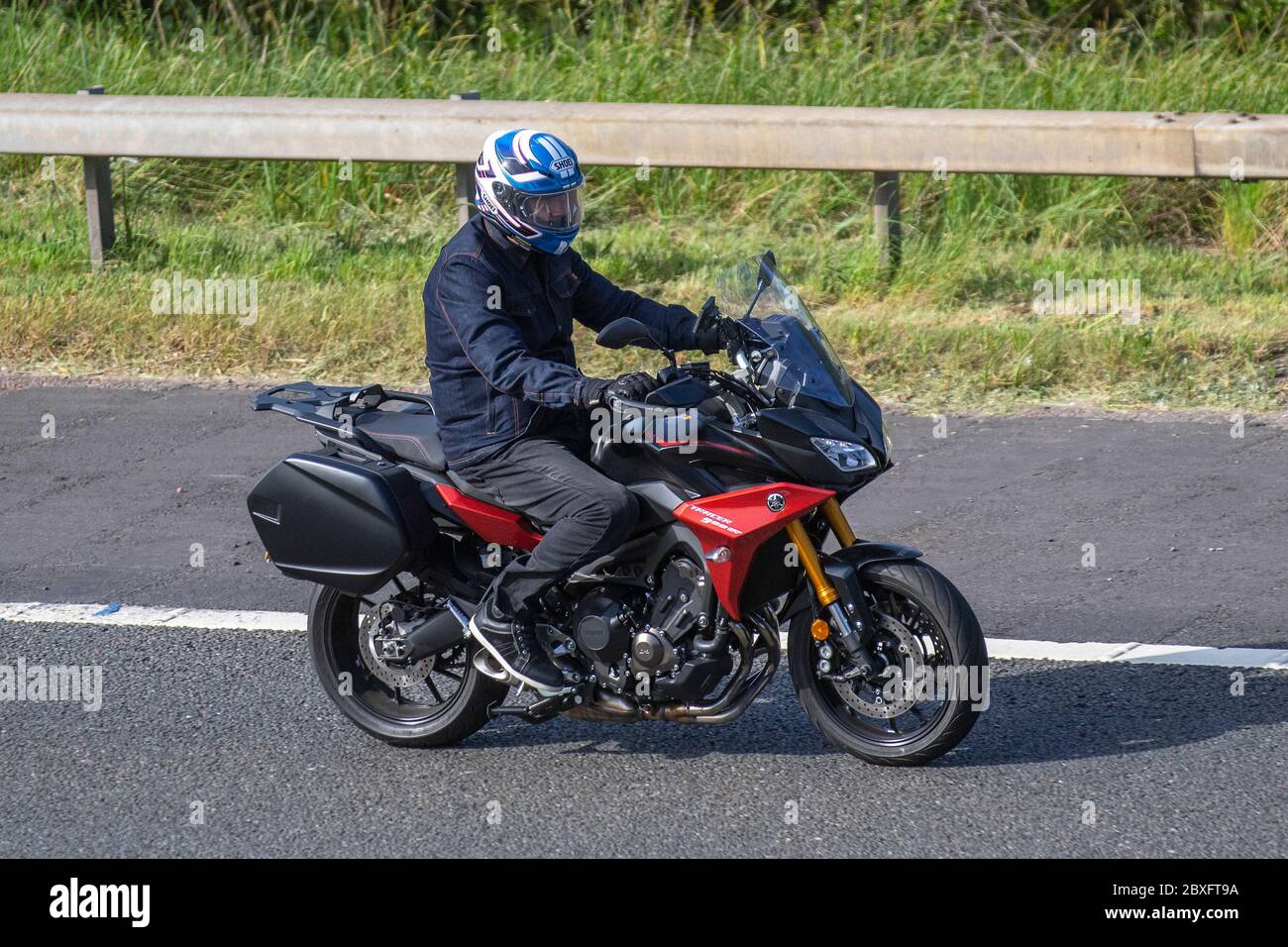 Yamaha Tracer 900GT Motorbike rider; two wheeled transport, motorcycles, vehicle, roads, motorbikes, bike riders motoring on the M6 motorway Chorley, UK Stock Photo