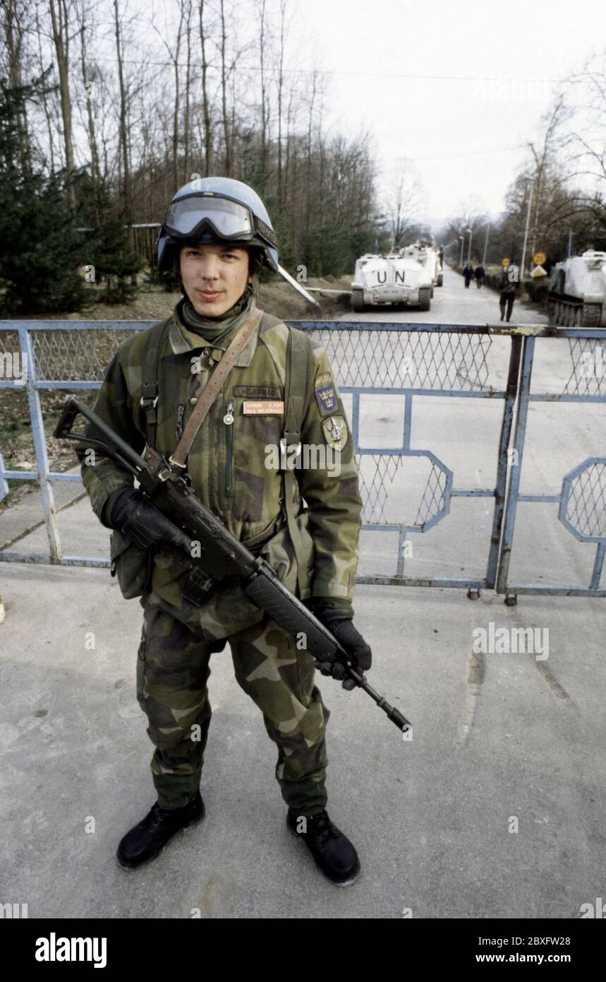 7th March 1994 During the war in Bosnia: armed with an Ak 5 (Automatkarbin 5) assault rifle, Sergeant Wejerhag, a Swedish soldier of Nordbat 2, stands guard at the gates to Tuzla Airport. Stock Photo