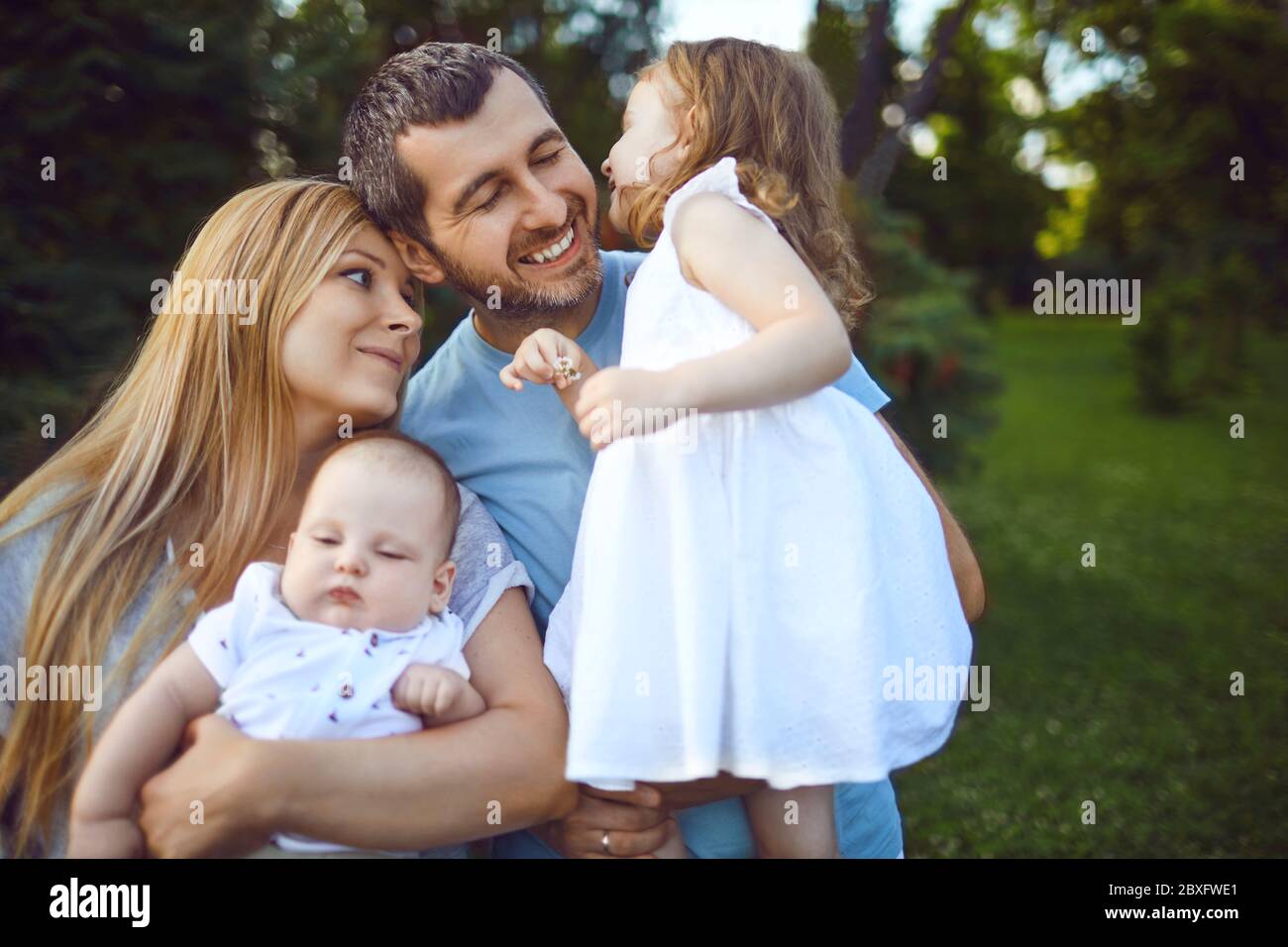 Mother father and children funny laughing outside Stock Photo - Alamy
