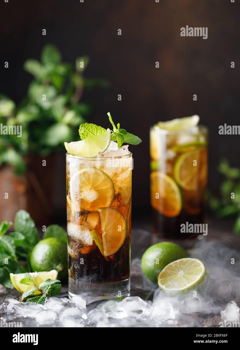 https://c8.alamy.com/comp/2BXFX6F/cuba-libre-with-brown-rum-cola-mint-and-lime-cuba-libre-or-long-island-iced-tea-cocktail-with-strong-drinks-2BXFX6F.jpg