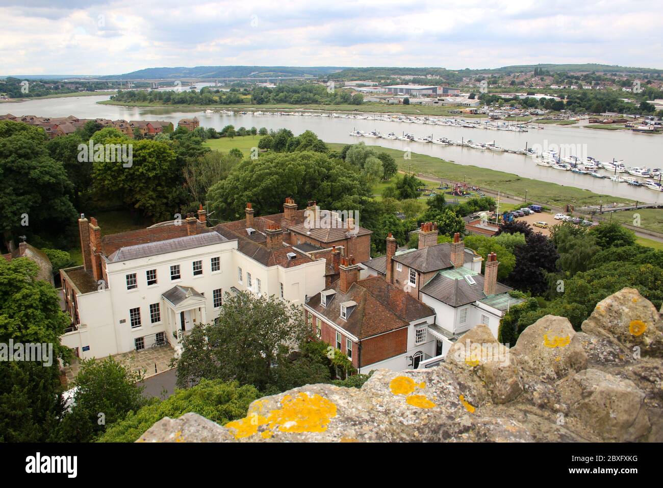 View of the River Medway with moored yachts and boats and houses in