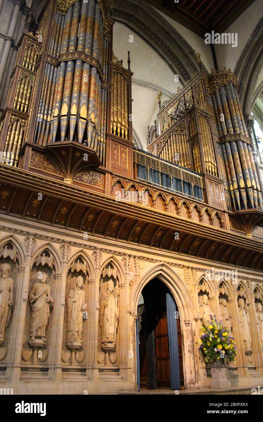 Organ pipes and stone statues in the interior of Rochester Cathedral