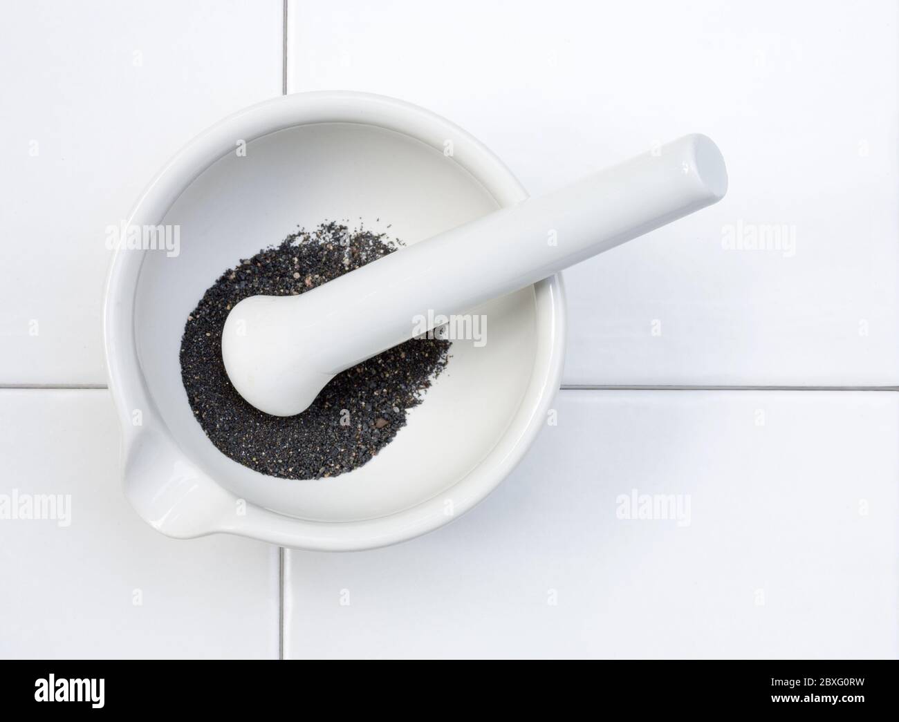 top view of laboratory mortar and pestle with ground mineral Stock
