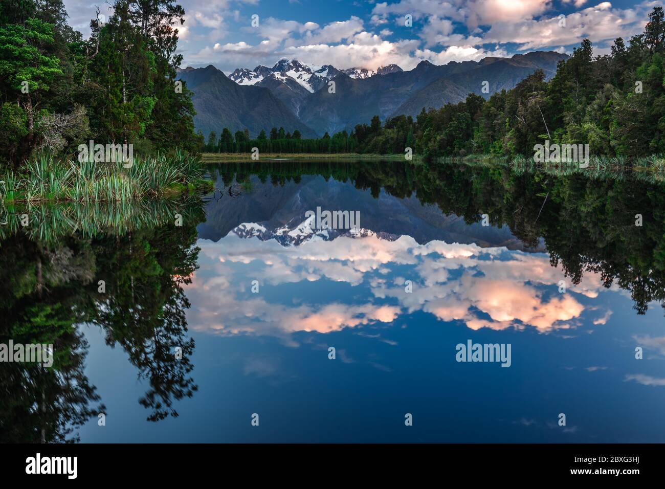 Twin Peaks reflect in the beautiful Lake Matheson, Southern Alps, South ...