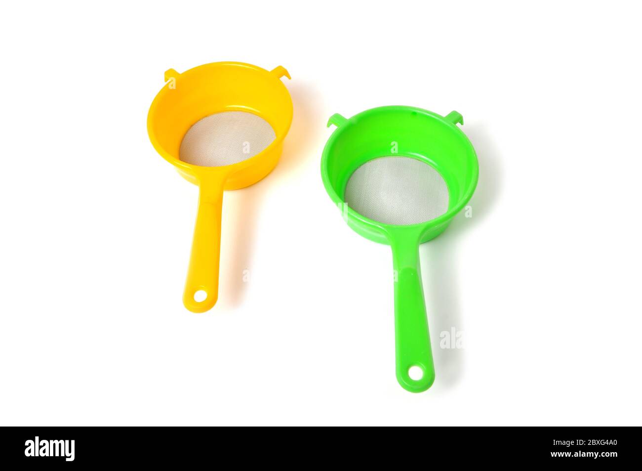Yellow and Green handle colander isolated on white background Stock