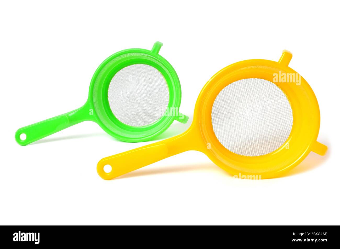 Yellow and Green handle colander isolated on white background Stock