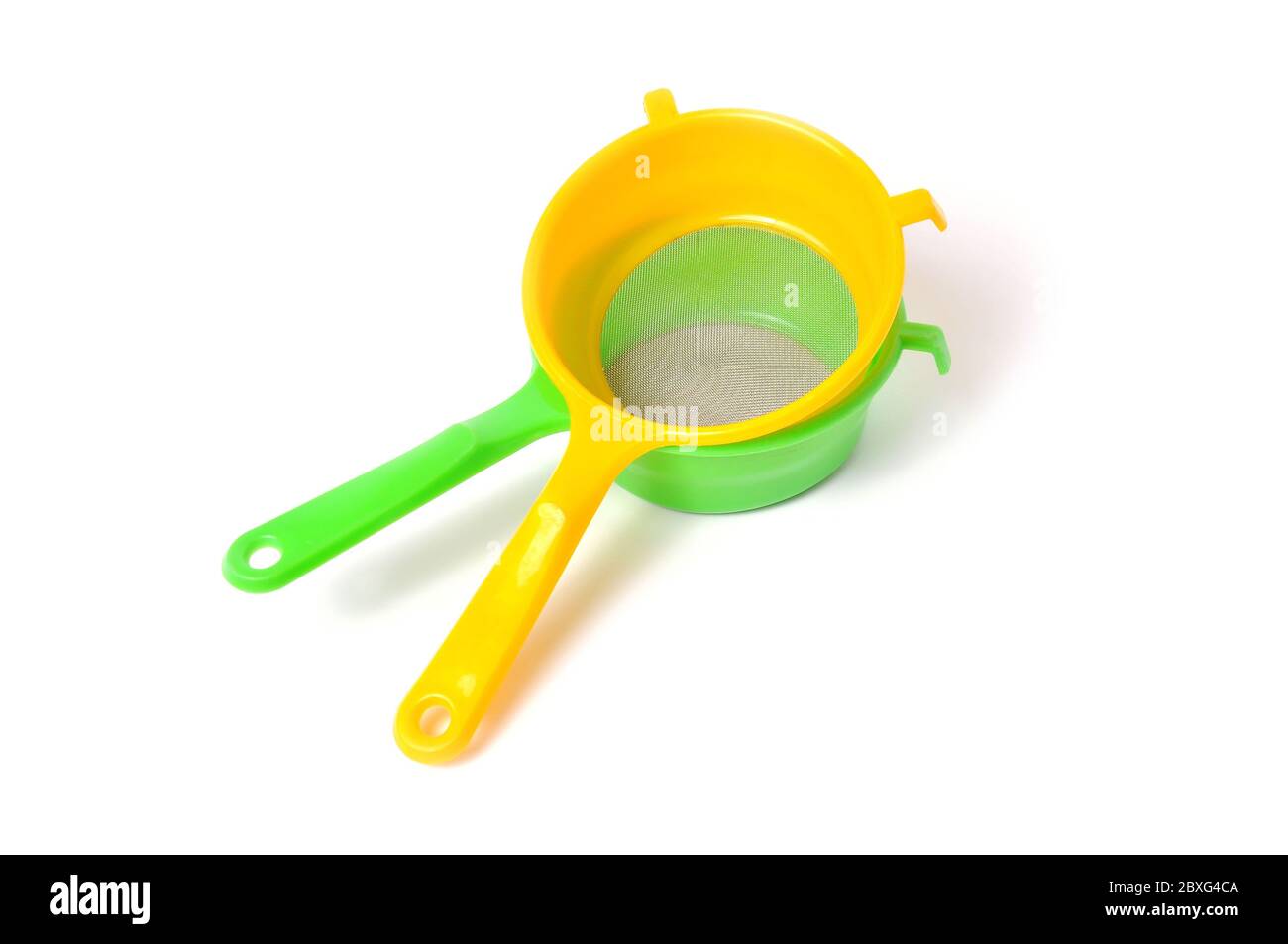 Yellow and Green handle colander isolated on white background Stock