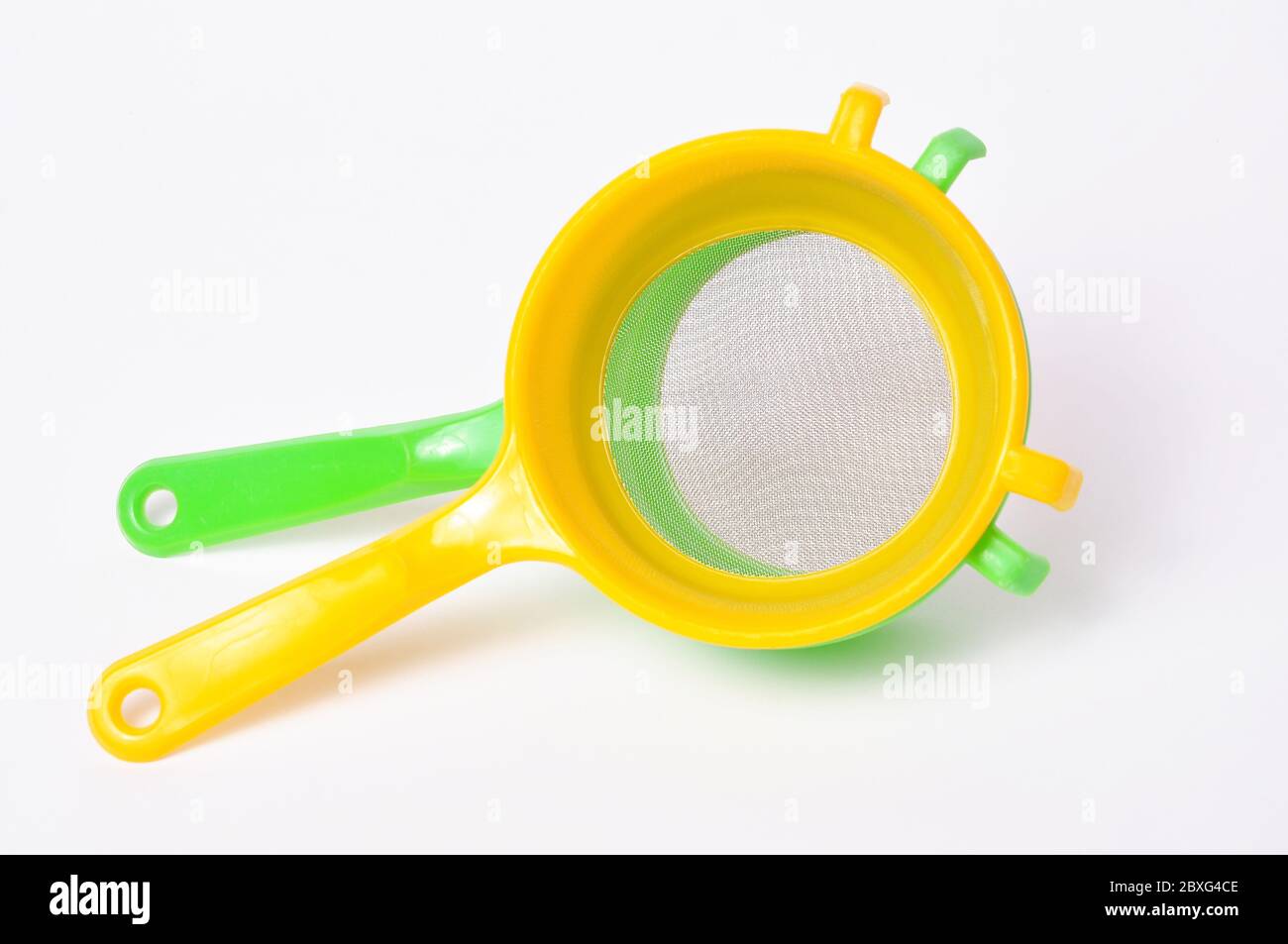Yellow and Green handle colander isolated on white background Stock