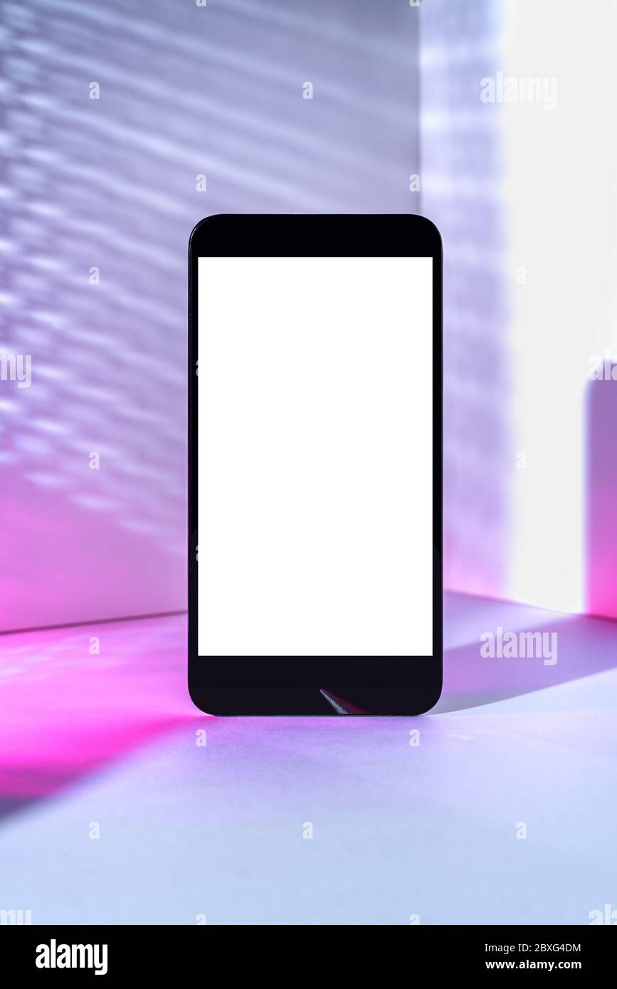 Minimalist modern smartphone mockup for presentation, in perspective in front of the corner angle of the wall, with overlapping shadows and gradient h Stock Photo