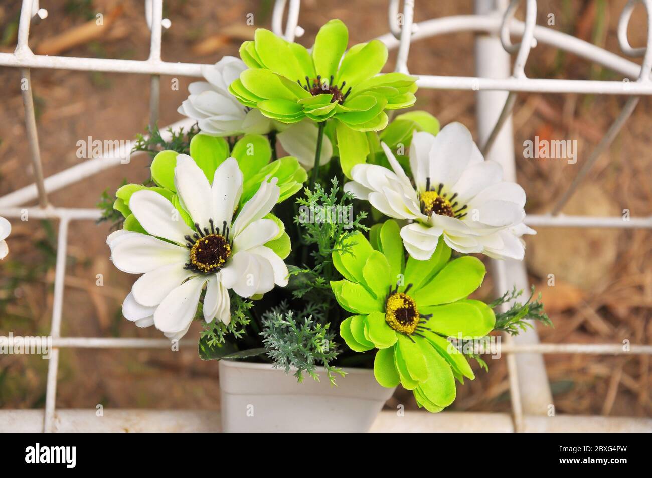 Green and white plastic flowers in a vase Stock Photo Alamy