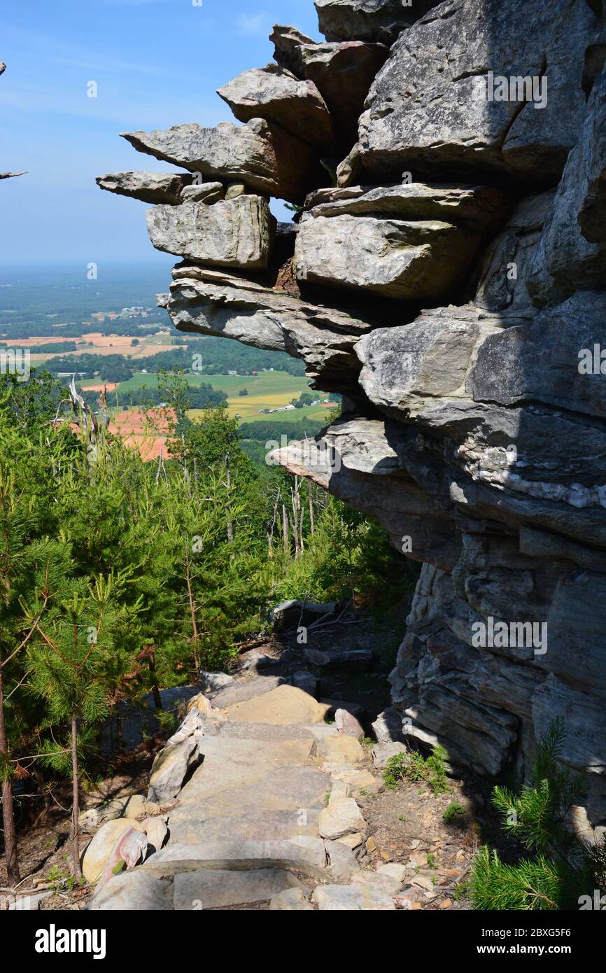 Rocks hang over the Ledge Spring hiking trail and Three Bears Pass at Pilot Mountain State Park