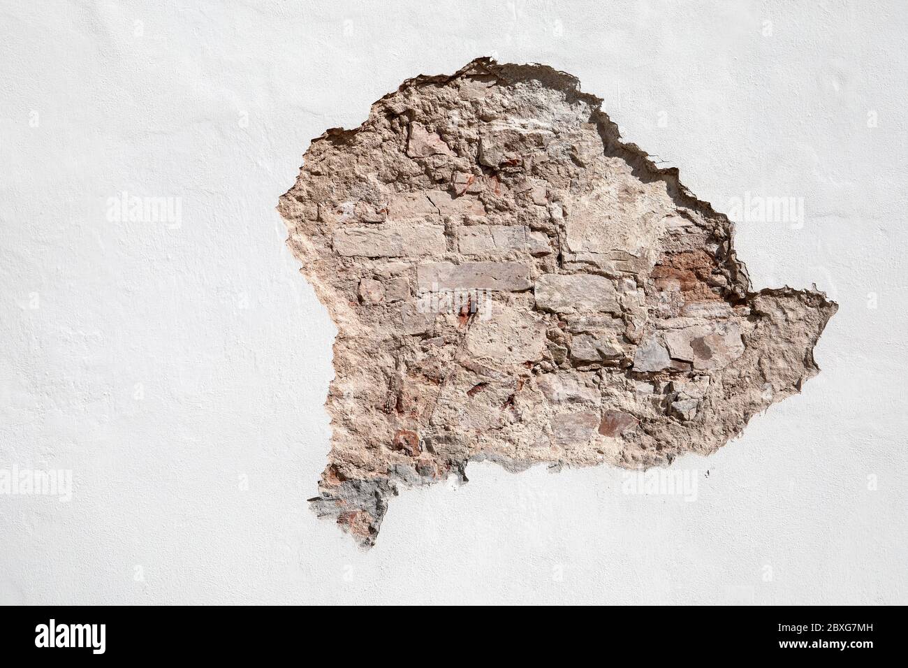 Through a hole in a wall it is visible bricks. Repair, restoration