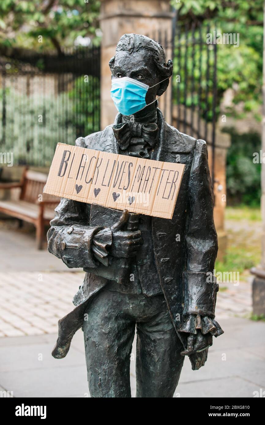 Edinburgh, Scotland. 7th June 2020. The statue of Robert Fergusson on the Royal Mile is given a face mask and a Black Lives Matter sign. Credit: Andrew Perry/Alamy Live News Stock Photo