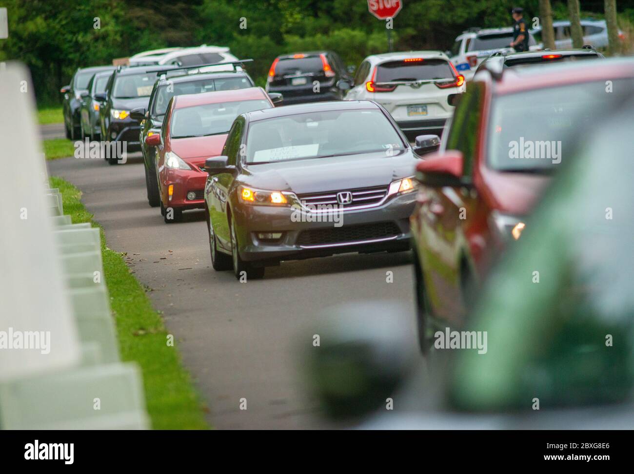 Vehicles make their way through the park during a socially distant car ...