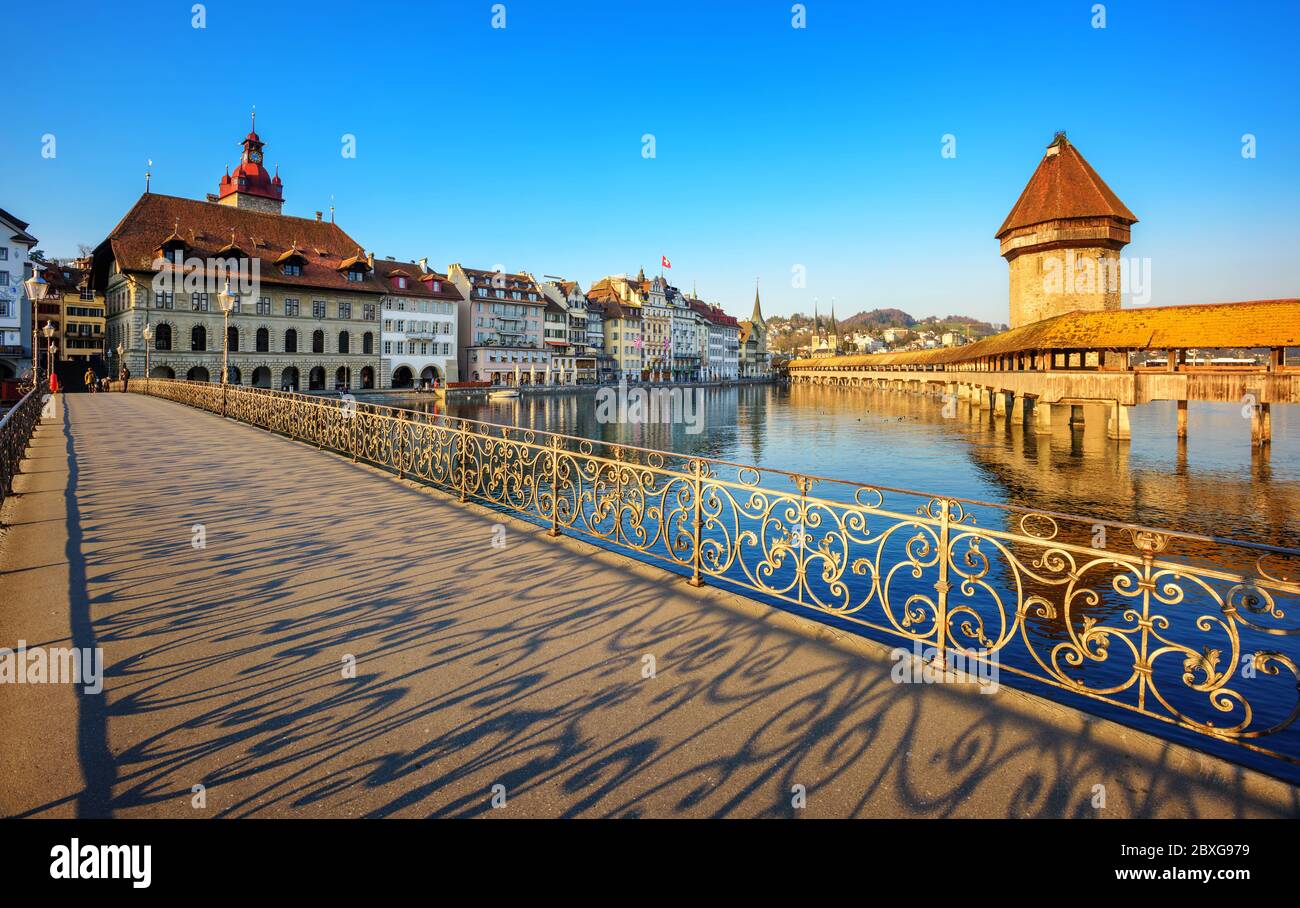 Lucerne city, Switzerland, ornate shadows cast by decorated balustrade on the pedestrian bridge in historical Old town on a sunny day Stock Photo