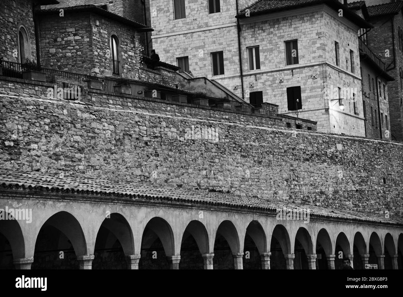 Black and white image of the buildings overlooking Piazza Inferiore di San Francesco, Assisi, Italy Stock Photo