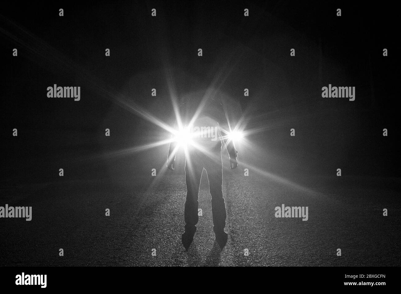 Man standing in front headlights Black and White Stock Photos & Images