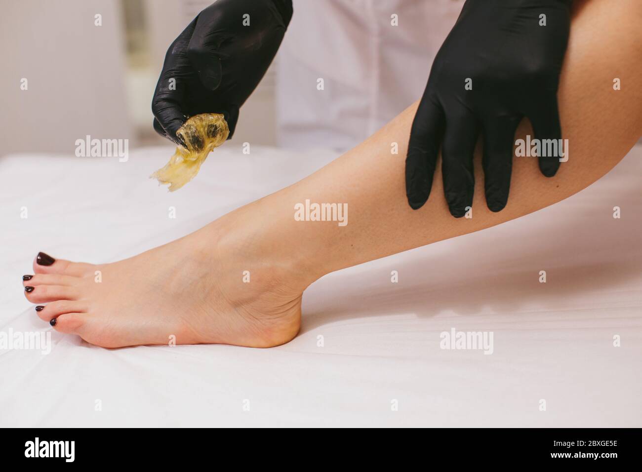 Woman having her leg waxed in a beauty salon Stock Photo