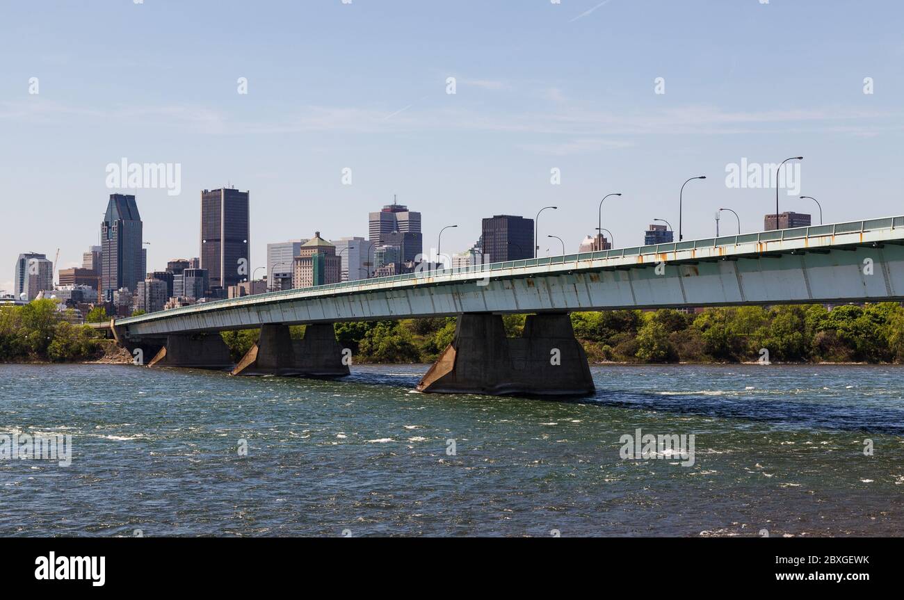 A view of downtown Montreal during the day showing the Pont de la Concorde bridge, buildings and offices. Stock Photo