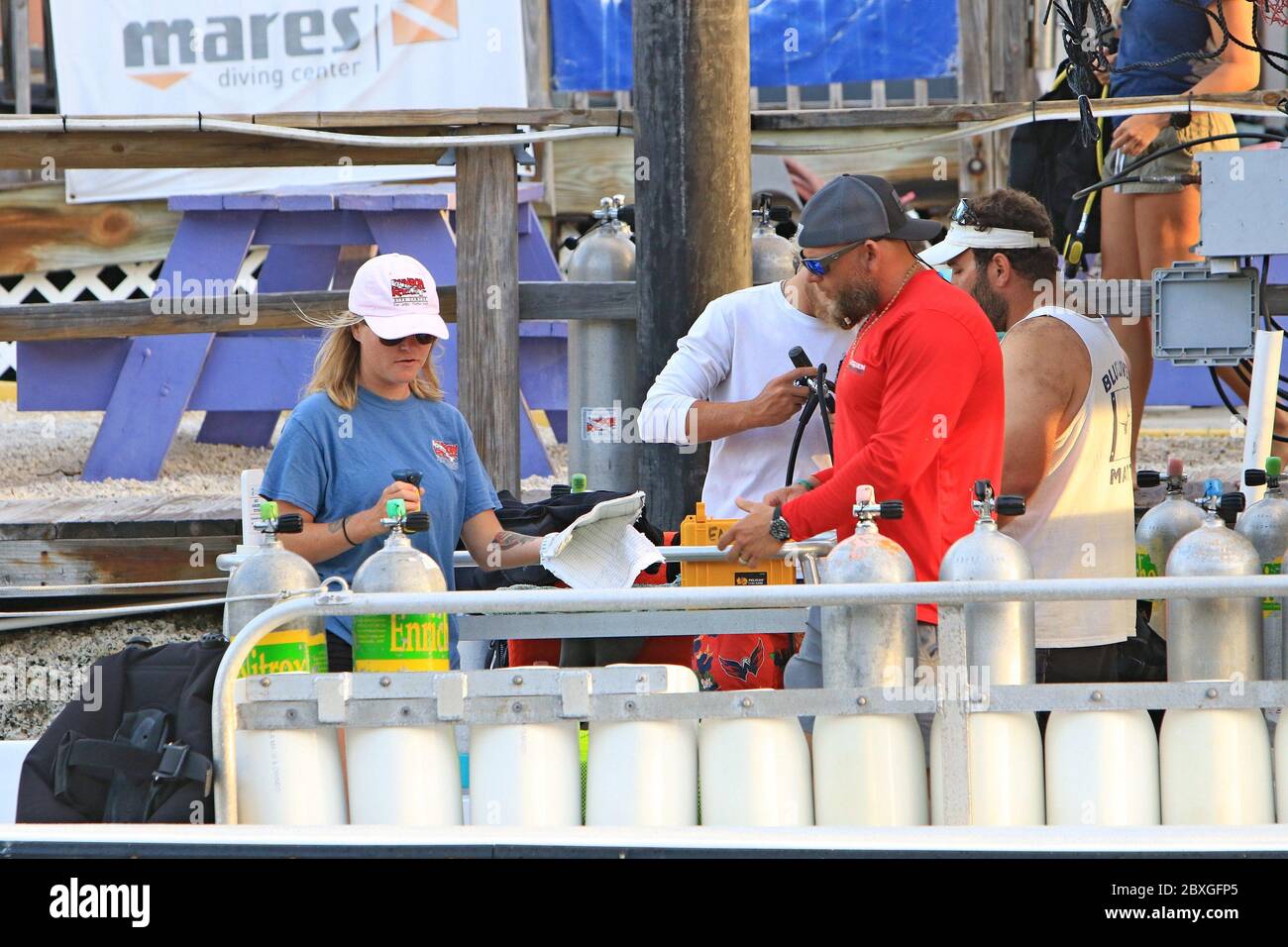 Key Largo, FL, 3/21/2020: Crew members are getting ready to take scuba divers out on their diving boat. Stock Photo