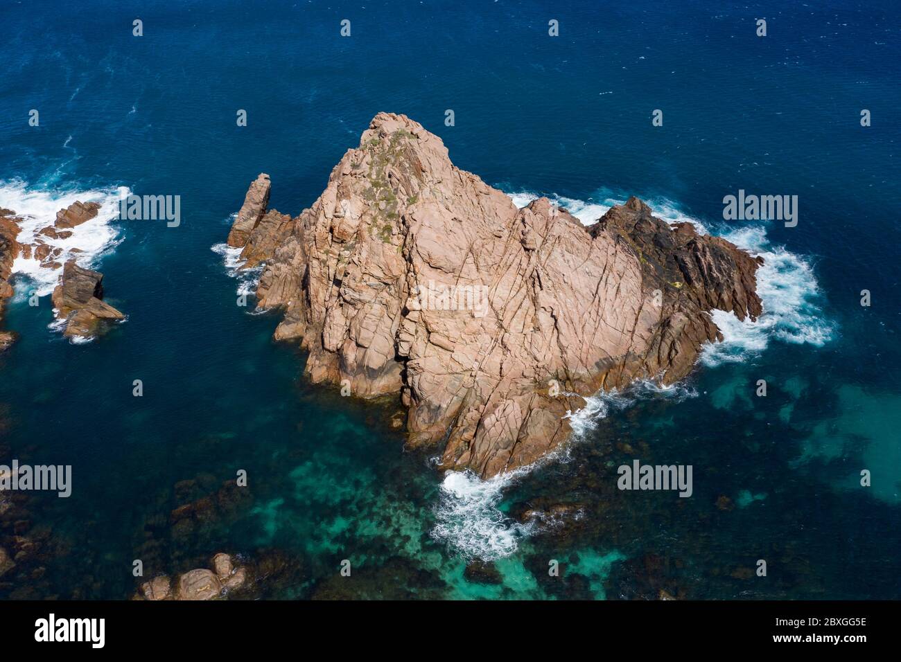 Aerial panorama of Sugarloaf Rock, which is a large, natural granite island in the Indian Ocean just off the coast approximately 2 kilometres south of Stock Photo