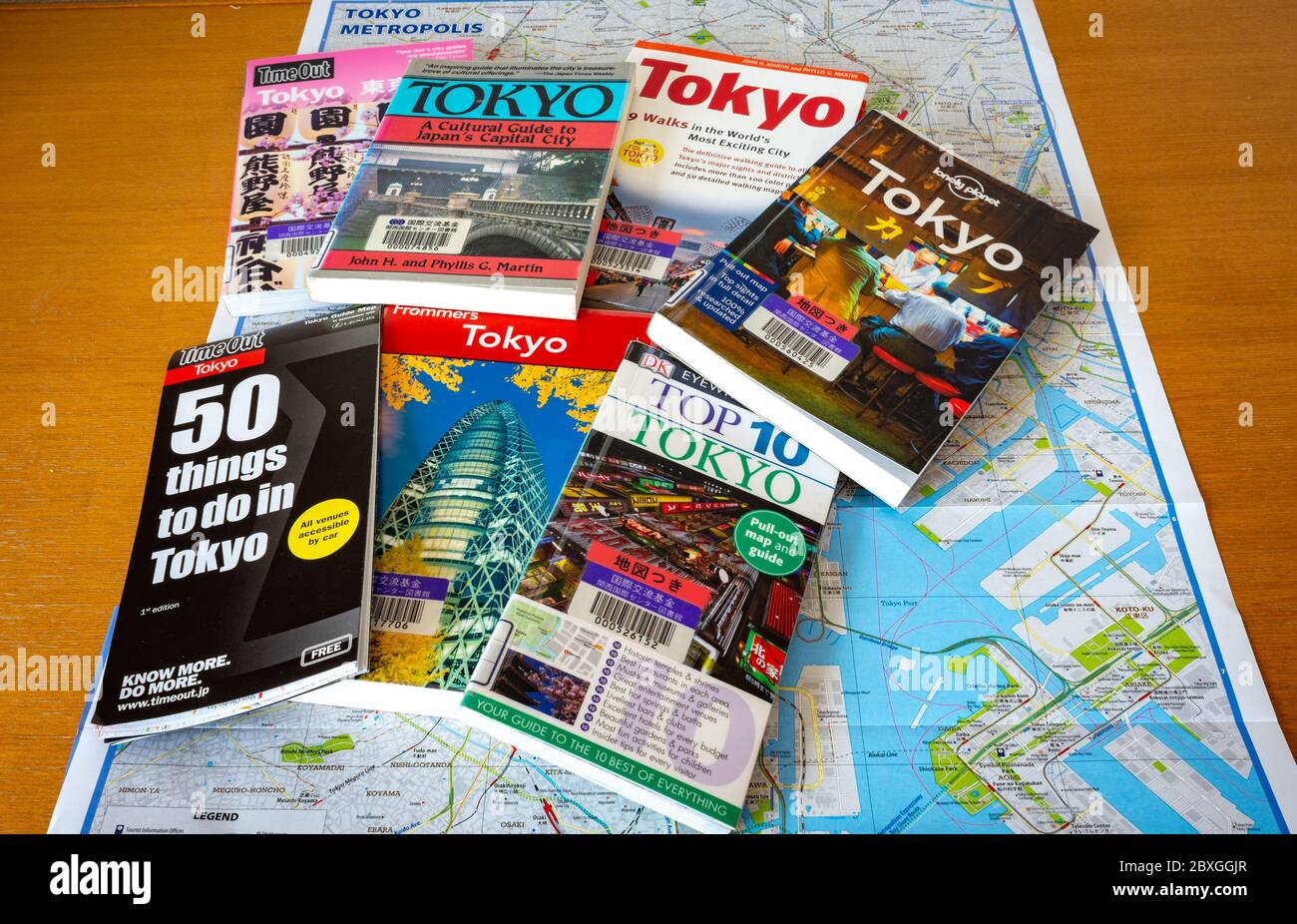Tokyo / Japan - October 15, 2017: Various Tokyo travel guides with Tokyo City Map spread on the table. Planning journey to Tokyo. Stock Photo