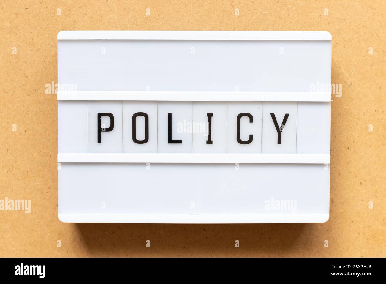 Lightbox with word policy on wood background Stock Photo