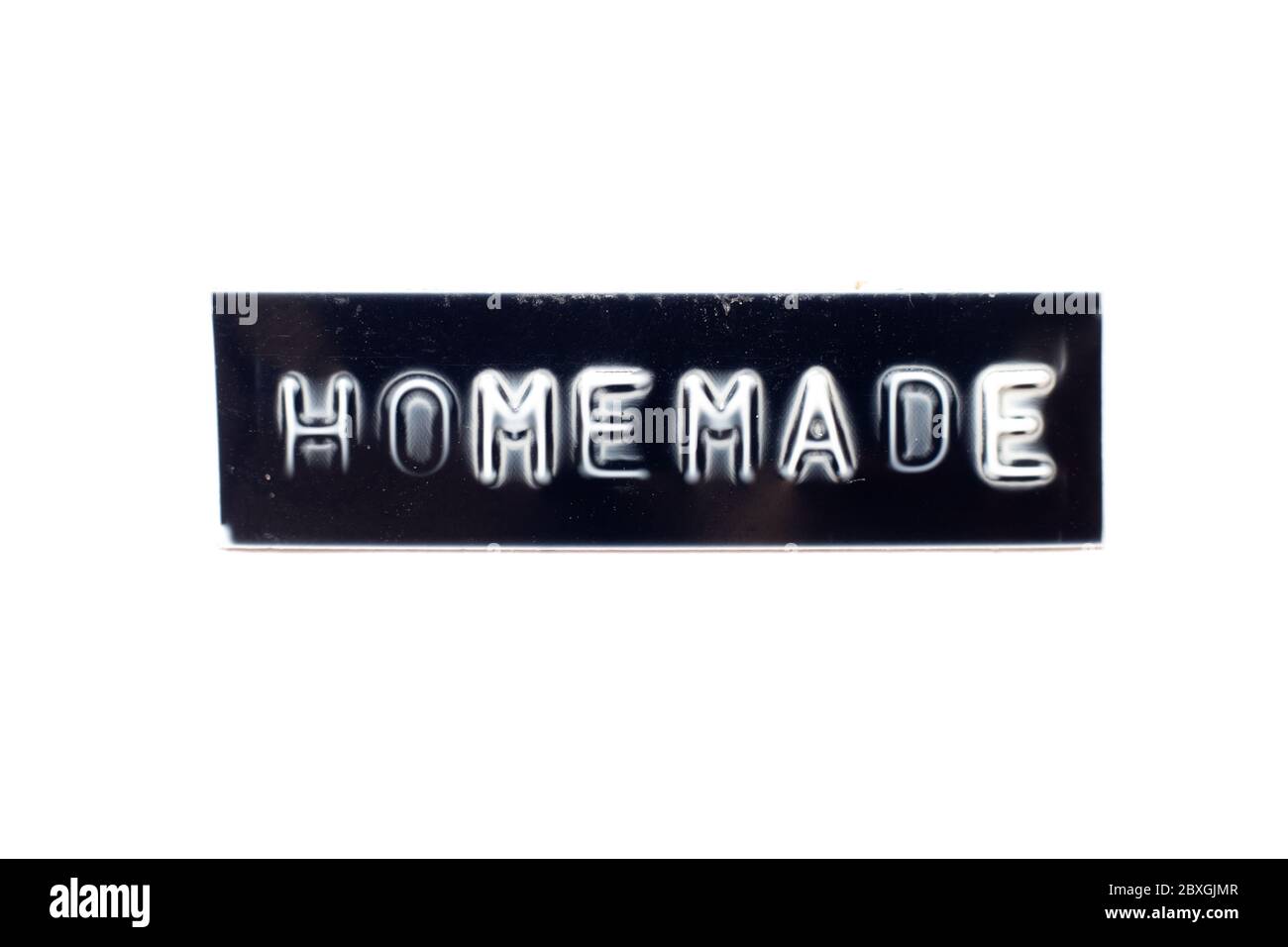 Embossed letter in word homemade in black banner on white background