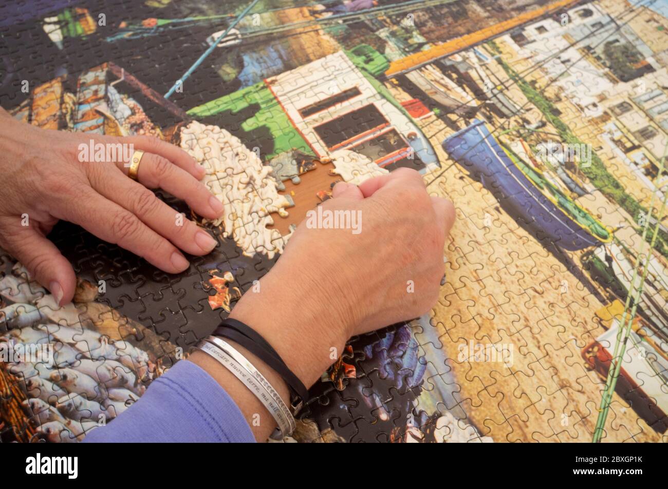 Focused on assembling a puzzle Stock Photo