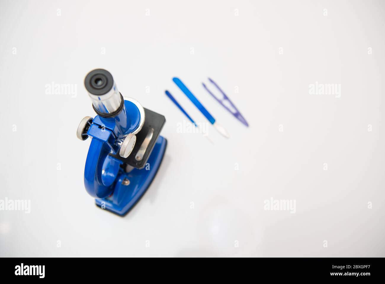 microscope isolated on a white background with research tools Stock Photo